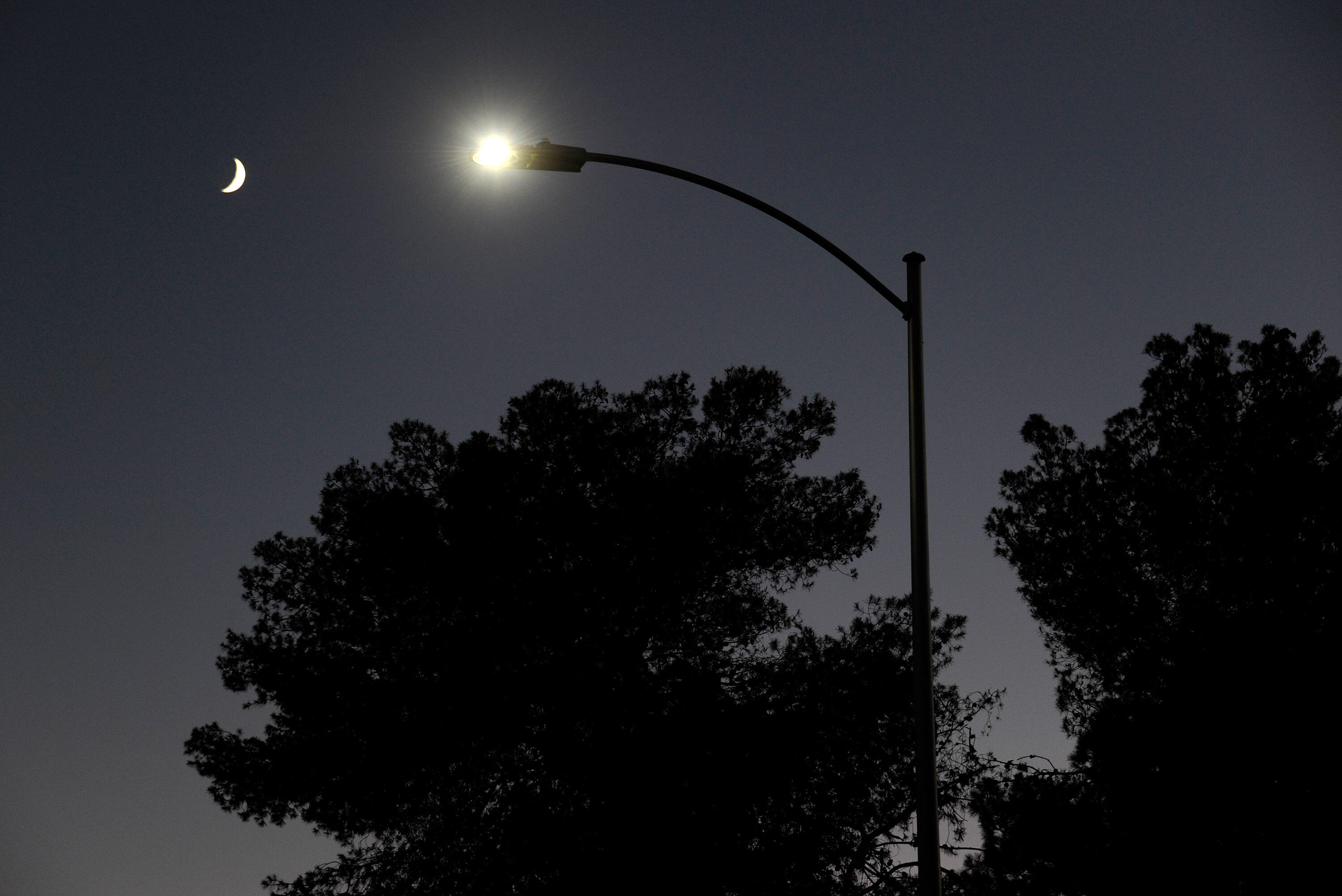 LAS VEGAS, NV - AUGUST 03:  A waxing crescent moon is seen behind a streetlight with a newly-installed LED fixture August 3, 2011 in Las Vegas, Nevada. The city is replacing 6,600 existing lights with the new energy-efficient LEDs, which are expected to reduce the city's annual electricity use by eight million kilowatt hours, saving about USD 400,000. The city estimates the LEDs will last about 15 years, nine years longer than the current lights. Funding for the project comes from federal energy conservation bonds and an American Recovery & Reinvestment Act grant. The city plans to replace all of its 50,000 streetlights after more funding is secured.  (Photo by Ethan Miller/Getty Images)