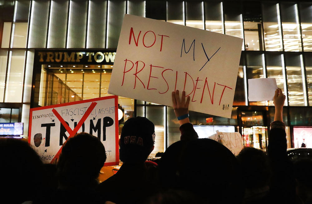 NEW YORK, NY - NOVEMBER 10:  Dozens of anti-Donald Trump protesters stand along 5th Avenue in front of Trump Tower as New Yorkers react for a second night to the election of Trump as president of the United States on November 10, 2016 in New York City. Trump defeated Democrat Hillary Clinton to become the 45th president.  (Photo by Spencer Platt/Getty Images)
