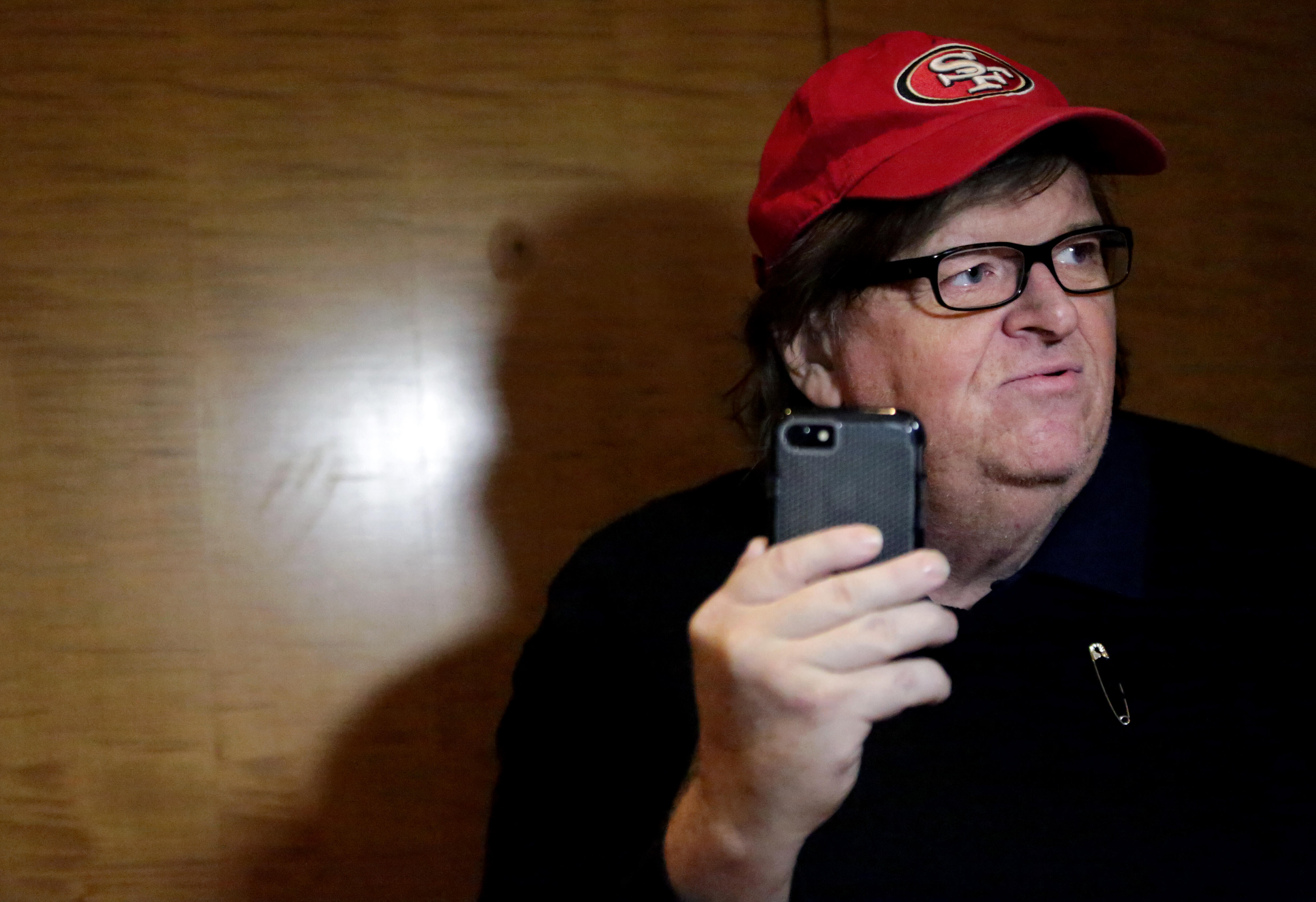 NEW YORK, NY - NOVEMBER 12: Filmmaker Michael Moore films himself with a smartphone at Trump Tower on November 12, 2016 in New York City. President-elect Donald Trump is holding meetings at his Trump Tower residence amid increased security in the area.  (