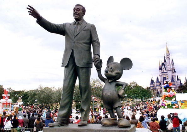 URAYASU, JAPAN:  Walt Disney and Mickey Mouse statues stand at the Tokyo Disneyland in Urayasu city, suburban Tokyo while visitors enjoy Disney characters' parade 13 November 2001, centennial anniversary of Walt Disney's birth becomes next month. The Orie