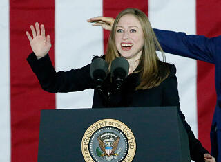 Chelsea Clinton speaks as her father former US President Bill Clinton gestures to the crowd during a rally for his wife Democratic presidential candidate Hillary Clinton on the final night of the 2016 US presidential campaign at Independence Mall in Phila