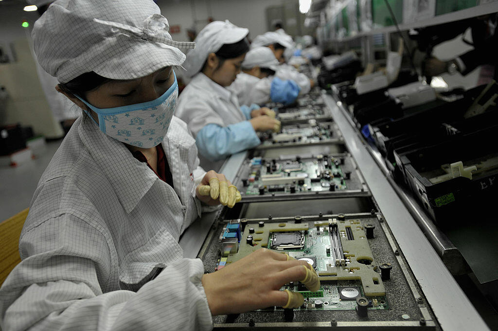 In a picture taken on May 26, 2010 Chinese workers assemble electronic components at the Taiwanese technology giant Foxconn's factory in Shenzhen, in the southern Guangzhou province. Foxconn on June 2 confirmed the death of another employee but denied he 