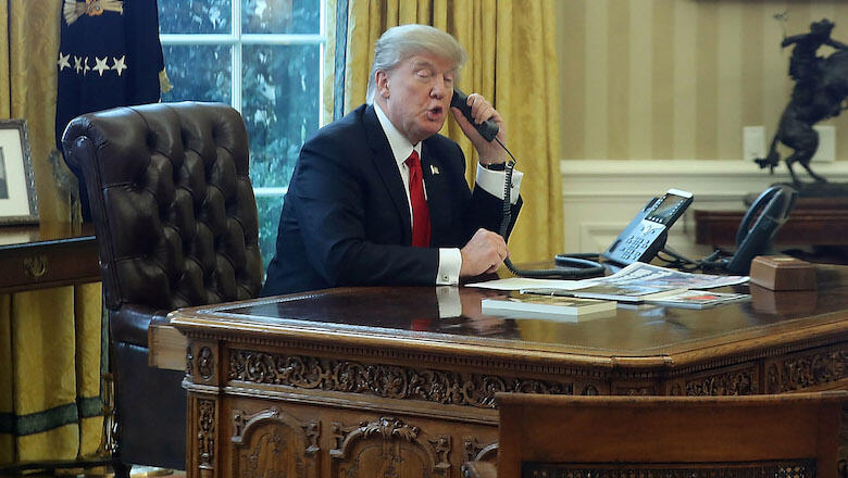 WASHINGTON, DC - JANUARY 29:  President Donald Trump is seen through a window speaking on the phone with King of Saudi Arabia, Salman bin Abd al-Aziz Al Saud, in the Oval Office of the White House, January 29, 2017 in Washington, DC. On Sunday, President 