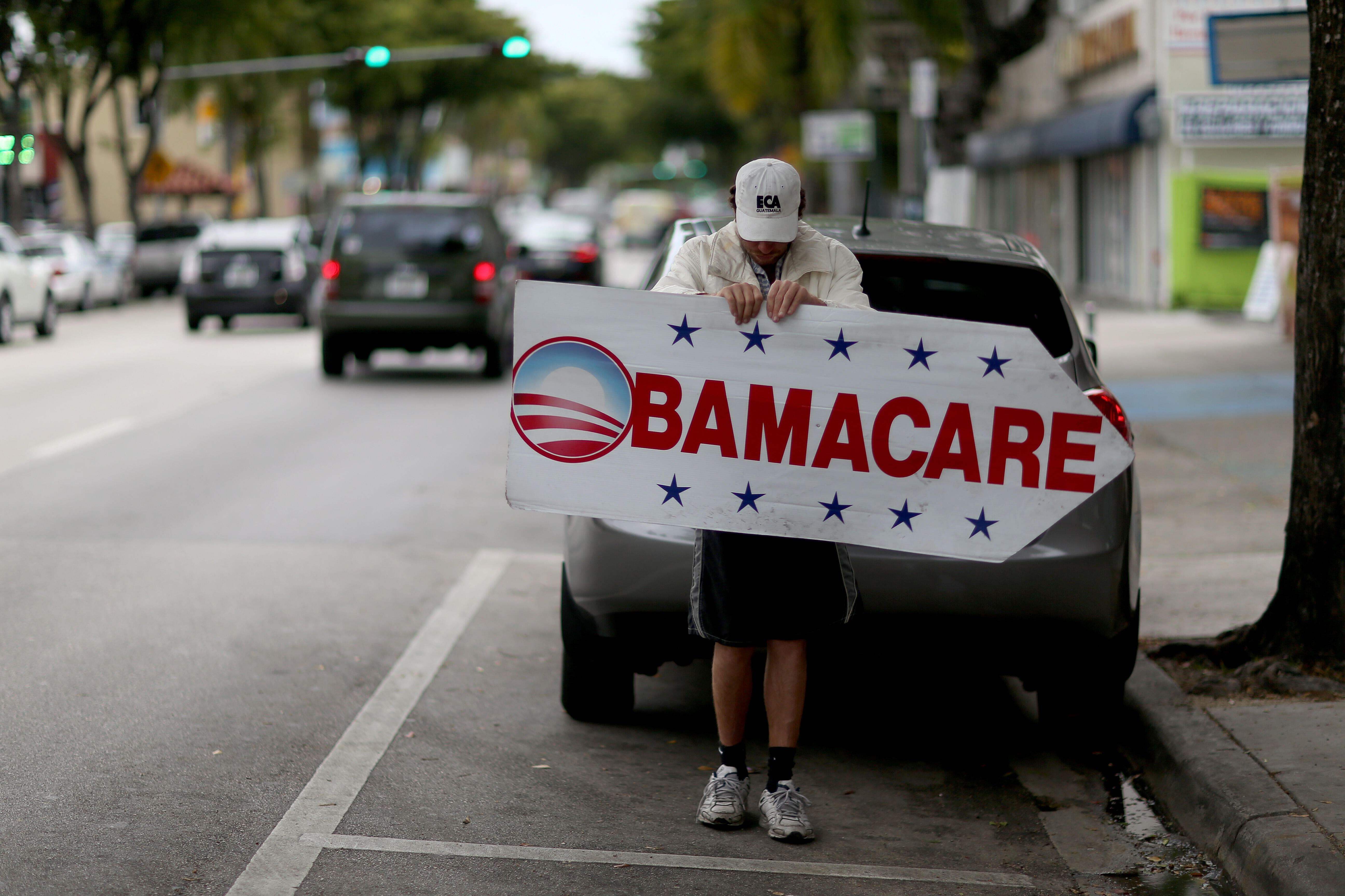 MIAMI, FL - FEBRUARY 05:  Pedro Rojas holds a sign directing people to an insurance company where they can sign up for the Affordable Care Act, also known as Obamacare, before the February 15th deadline on February 5, 2015 in Miami, Florida. Numbers relea