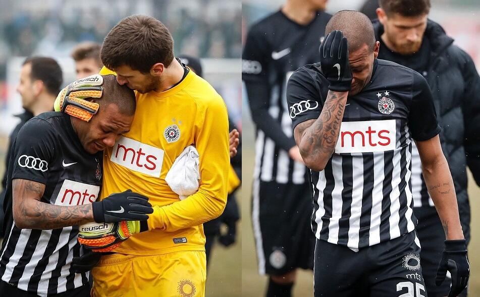 Partizan Belgrade's goalkeeper Filip Kljajic (R) hugs Brazilian midfielder Everton Luiz as he leaves the field in tears on February 19, 2017, at the end of a Serbian championship match between Partizan and Rad, after racist remarks from Rad's supporters, 