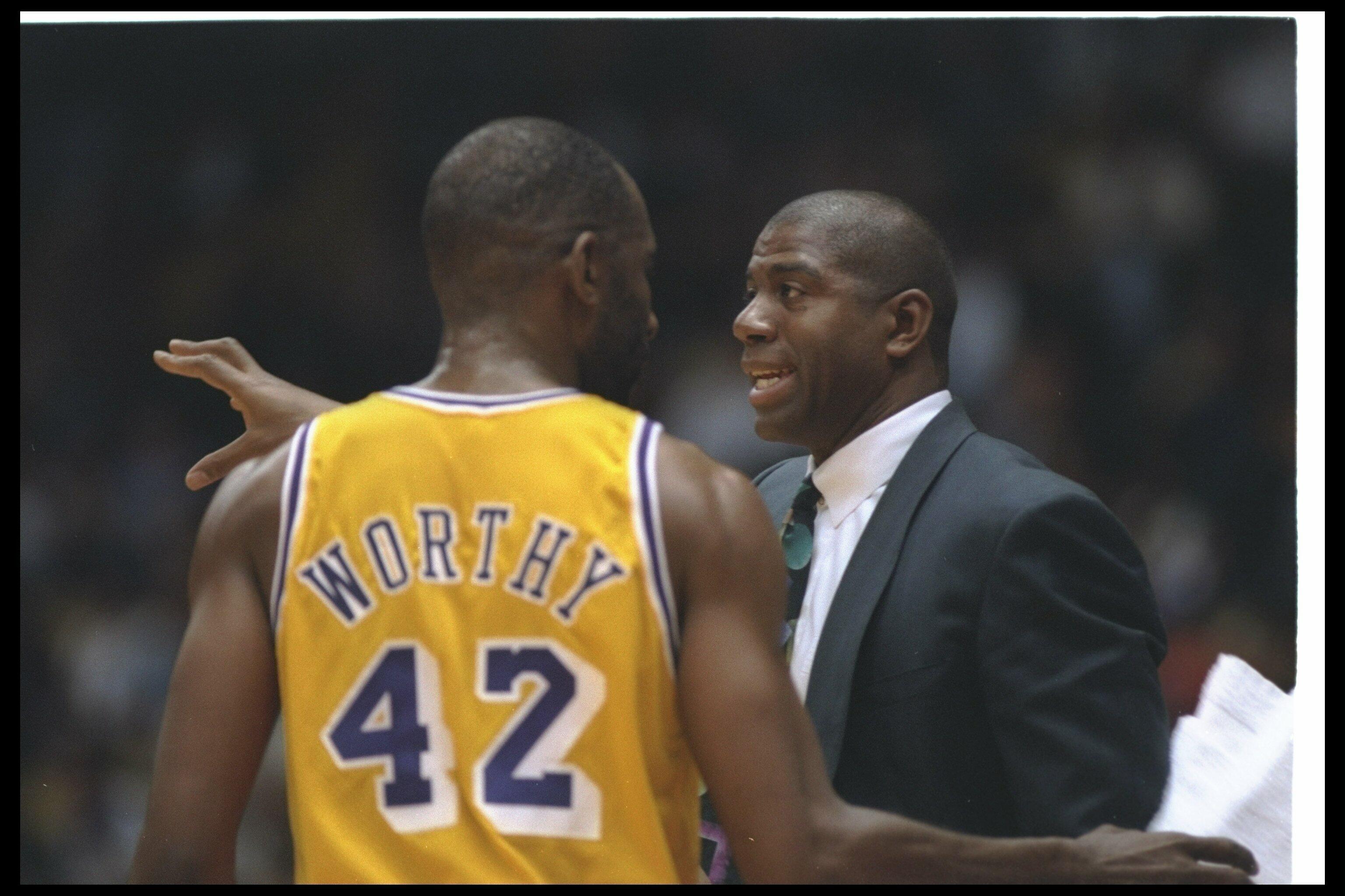 29 Mar 1994:  Los Angeles Lakers head coach Earvin (Magic) Johnson confers with forward James Worthy during a game against the Minnesota Timberwolves at the Great Western Forum in Inglewood,California. Mandatory Credit: Stephen Dunn  /Allsport Mandatory C