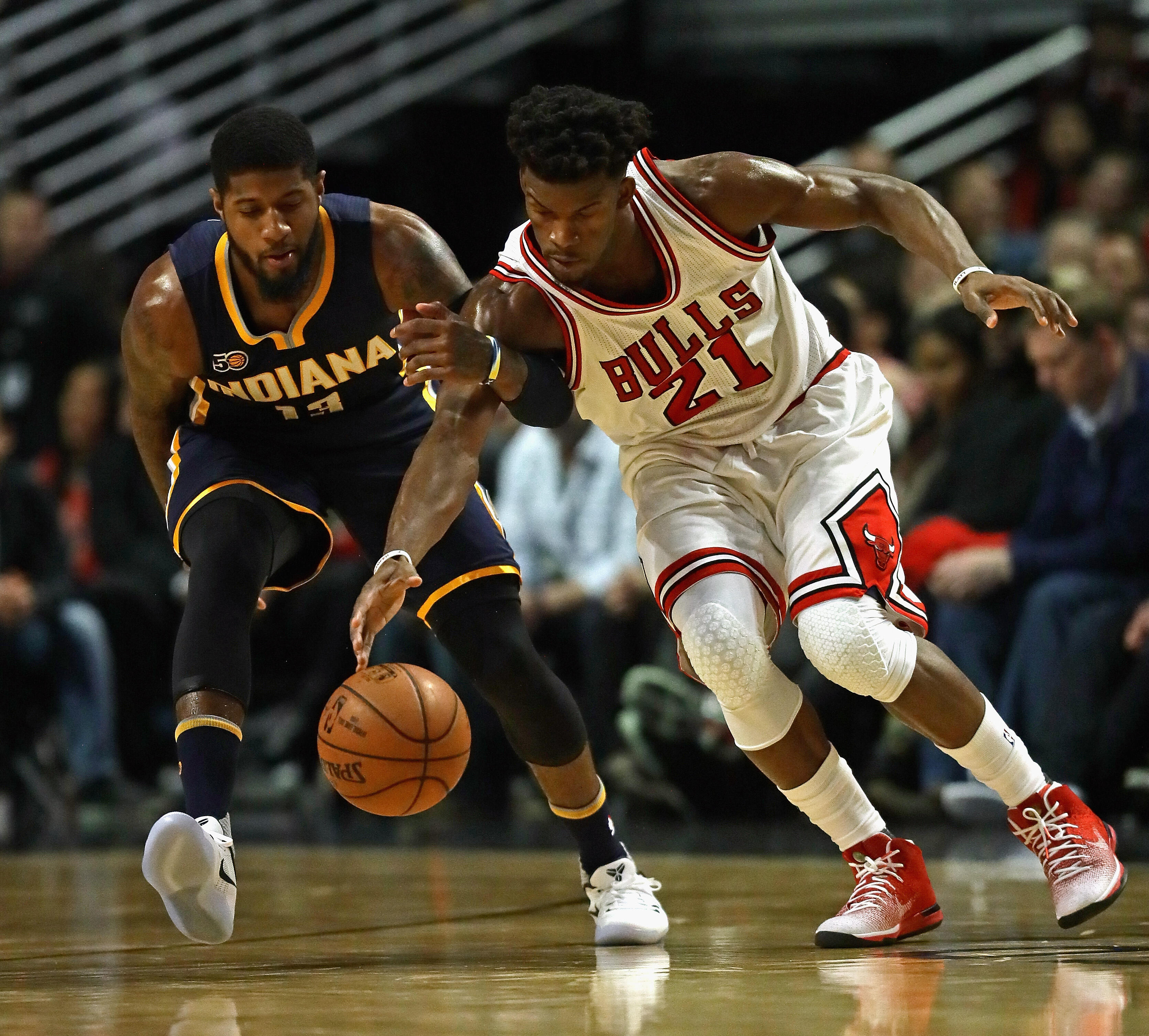 CHICAGO, IL - DECEMBER 26: Jimmy Butler #21 of the Chicago Bulls and Paul George #13 of the Indiana Pacers chase down a loose ball at the United Center on December 26, 2016 in Chicago, Illinois. (Photo by Jonathan Daniel/Getty Images)