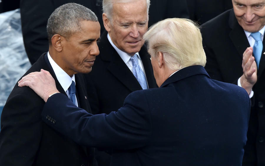 US President Donald Trump(C)speaks with former President Barack Obama as former Vice President Joe Biden and New York Sen. Chuck Schumer look on during his inauguration ceremonies at the US Capitol in Washington, DC, on January 20, 2017. / AFP / Paul J. R