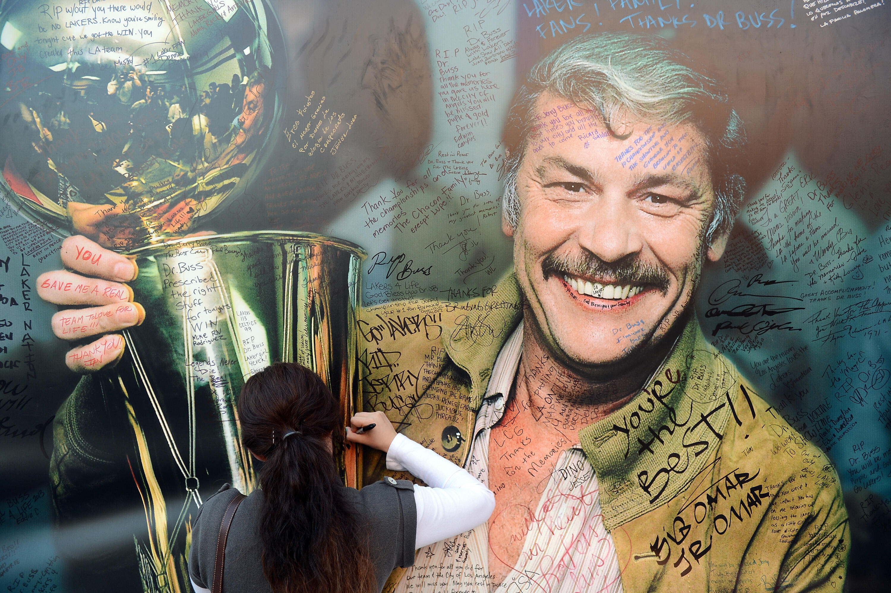 LOS ANGELES, CA - FEBRUARY 21:  Fans sign the display of Dr. Jerry Buss after his memorail service outside the Nokia Theatre L.A. Live on February 21, 2013 in Los Angeles, California.  (Photo by Harry How/Getty Images)