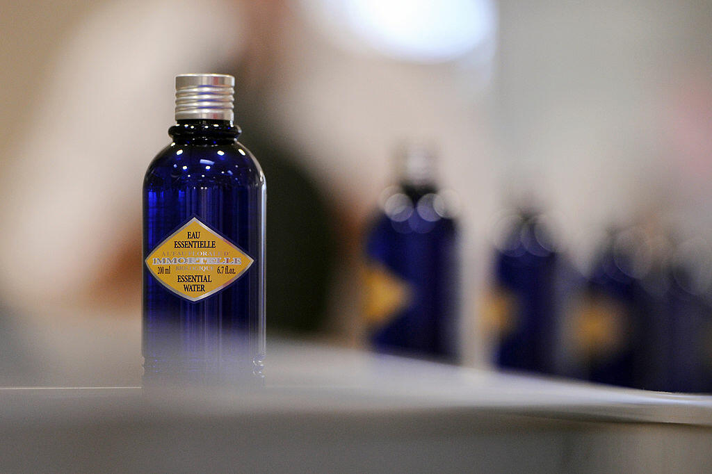 A picture taken on October 24, 2013 shows bottles of essential water on an assembly line at French cosmetics company L'Occitane production site in Manosque, southeastern France. 
