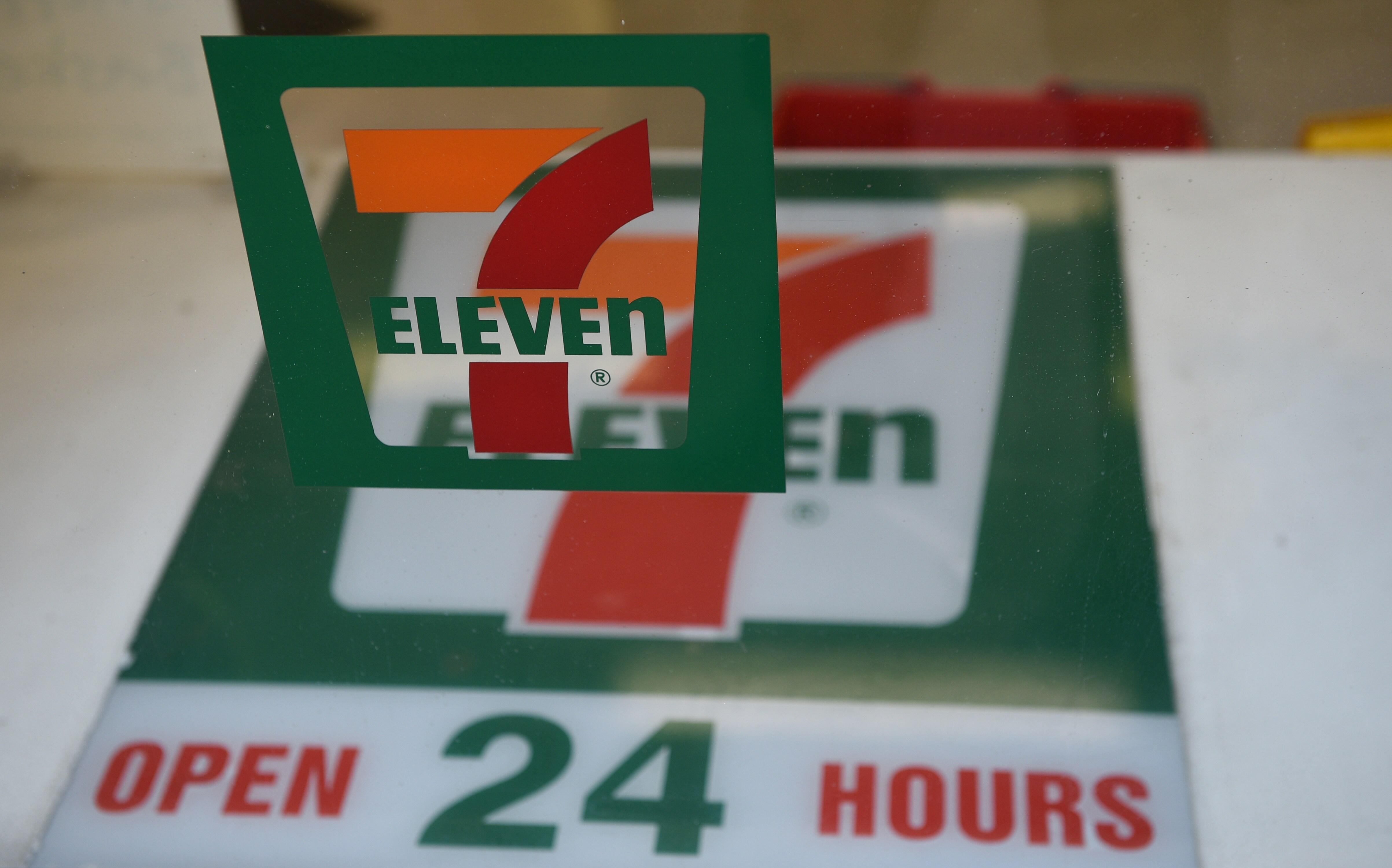 A sign for a 7-Eleven convenience store is seen at a store in Sydney on September 1, 2015. The convenience store giant will establish an independent panel to review damaging allegations that its franchisees doctored payrolls and systematically underpay wo