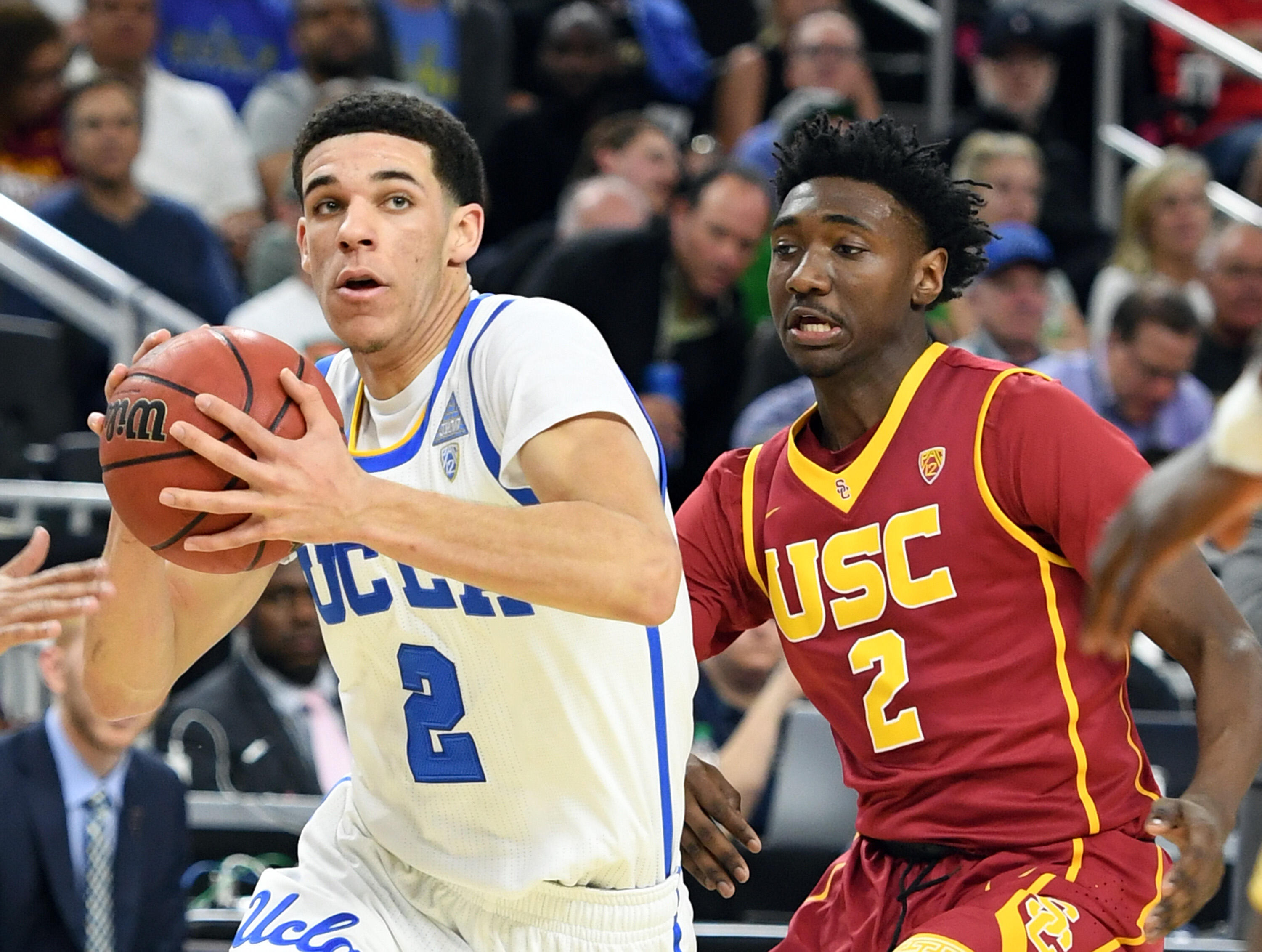 LAS VEGAS, NV - MARCH 09:  Lonzo Ball #2 of the UCLA Bruins drives to the basket against Jonah Mathews #2 of the USC Trojans during a quarterfinal game of the Pac-12 Basketball Tournament at T-Mobile Arena on March 9, 2017 in Las Vegas, Nevada. UCLA won 7