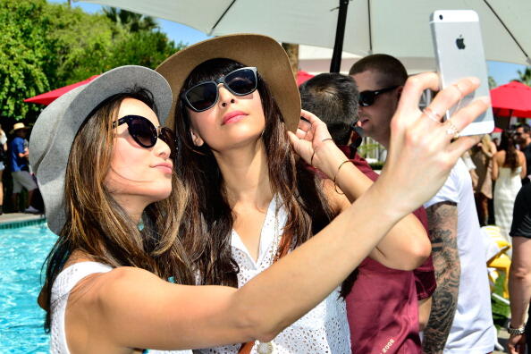 PALM SPRINGS, CA - APRIL 12: Jamie Chung and Hannah Simone pose for a selfie at the GUESS Hotel at the Viceroy Palm Springs on April 12, 2014 in Palm Springs, California.  (Photo by Jerod Harris/Getty Images for GUESS)