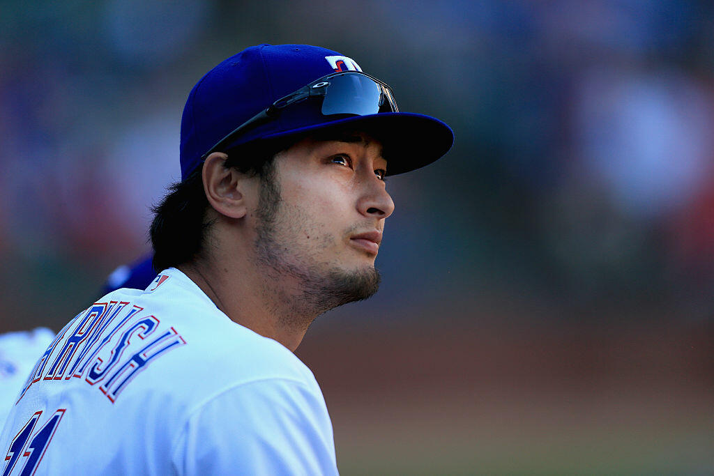 ARLINGTON, TEXAS - APRIL 04:  Yu Darvish #11 of the Texas Rangers looks on from the dugout as the Rangers take on the Seattle Mariners in the top of the eighth inning on Opening Day at Globe Life Park in Arlington on April 4, 2016 in Arlington, Texas.  (Photo by Tom Pennington/Getty Images)
