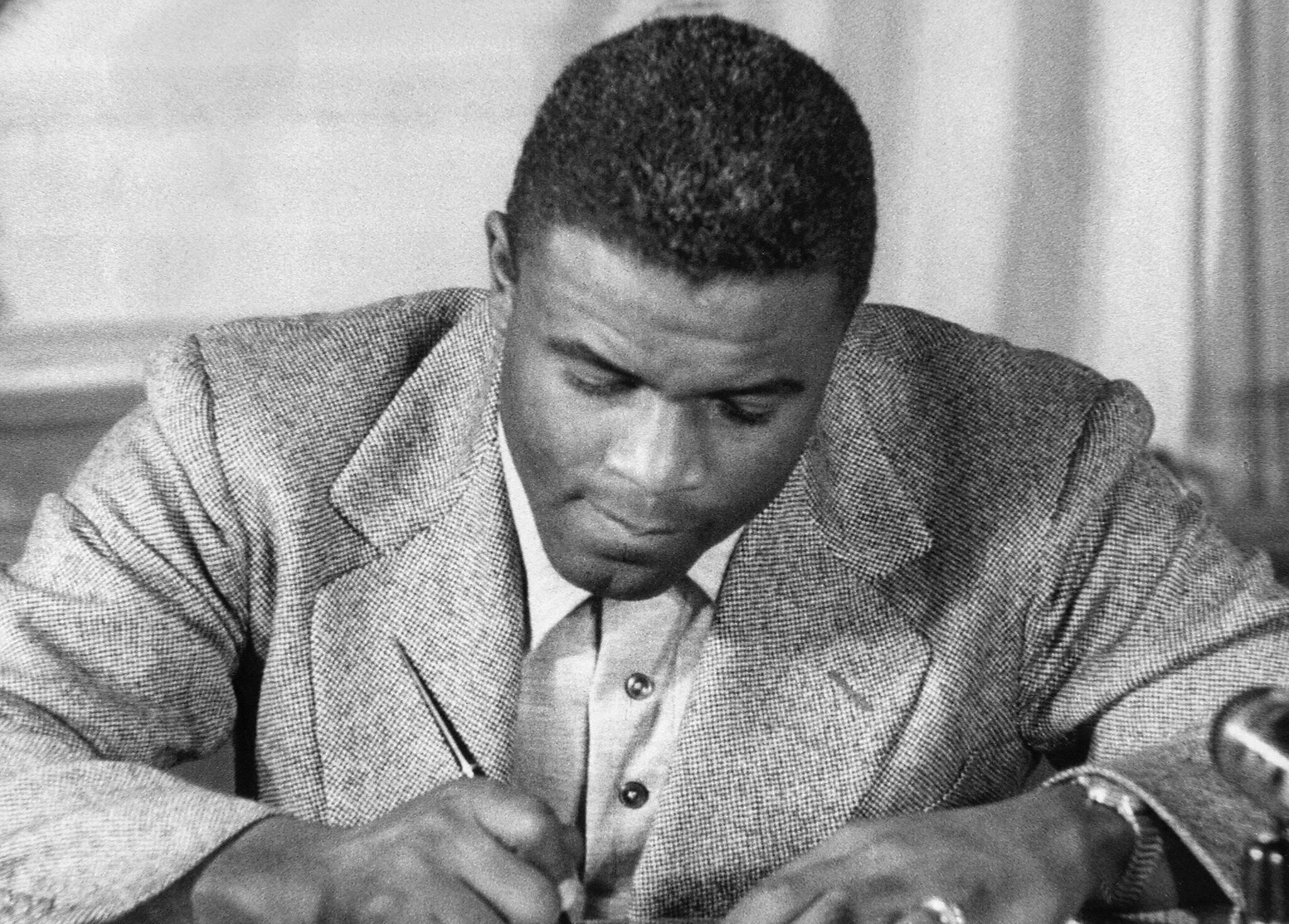 NEW YORK, UNITED STATES:  (FILES)This undated file photo shows US baseball star Jackie Robinson as he signs a then-record contract to play for the Brooklyn Dodgers in New York. Robinson has been chosen to receive posthumously the Congressional Gold Medal,