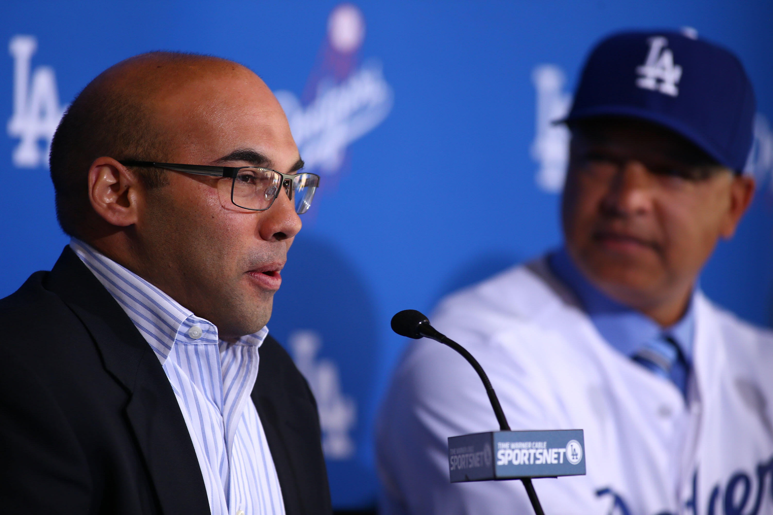 LOS ANGELES, CA - DECEMBER 01:  Farhan Zaidi, Los Angeles Dodgers general manager, left, speaks as Dave Roberts, right, looks on during a press conference to introduce Roberts as the new Los Angeles Dodgers manager at Dodger Stadium on December 1, 2015 in