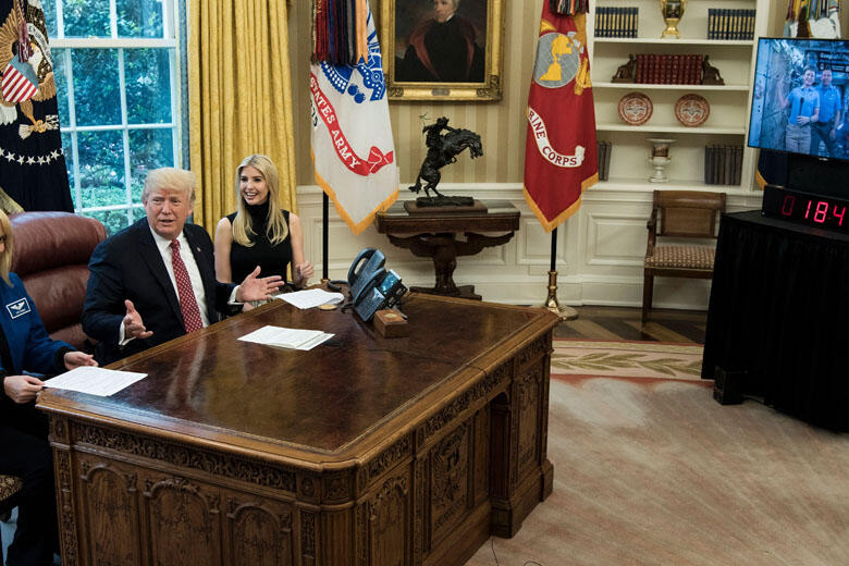 NASA Astronaut Kathleen Rubins (L) and Ivanka Trump (3L) sit with US President Donald Trump (2L) after he spoke via video with NASA astronauts aboard the International Space Station from the Oval Office of the White House April 24, 2017 in Washington, DC.