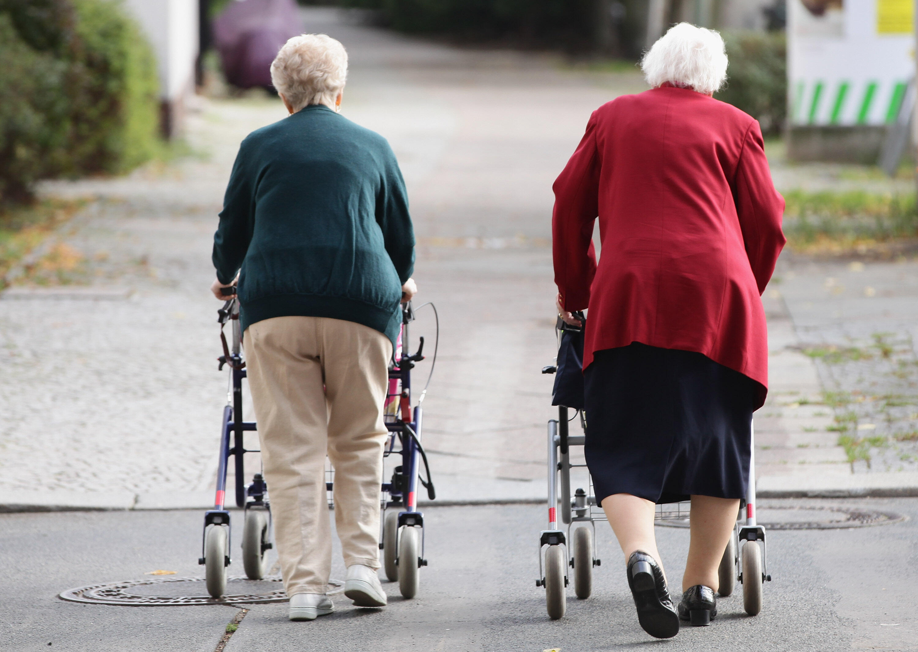 BERLIN - SEPTEMBER 10:  Two elderly women push shopping carts down a street on September 10, 2010 in Berlin, Germany. Germany's elderly population is growing and its overall population is shrinking. Demographers and economists argue that the German govern