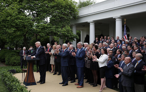 WASHINGTON, DC - MAY 04:  Republican House members join U.S. President Donald Trump on stage as he speaks during a Rose Garden event May 4, 2017 at the White House in Washington, DC. The House has passed the American Health Care Act that will replace the Obama eraÕs Affordable Healthcare Act with a vote of 217-213.  (Photo by Alex Wong/Getty Images)