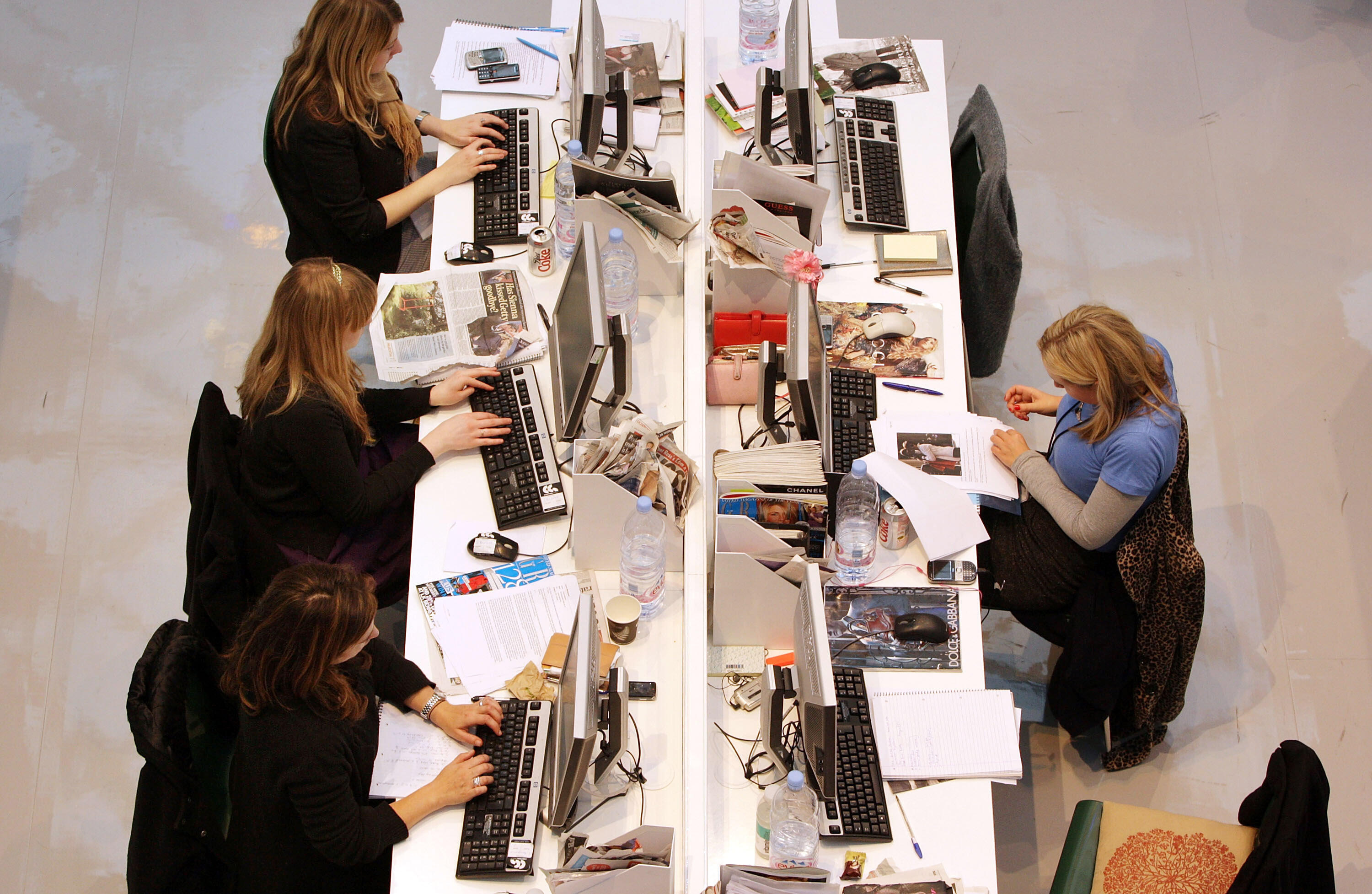 LONDON - NOVEMBER 03:  Production staff on the weekly fashion magazine, Grazia edit the magazine in a temporary office inside the Westfield shopping centre on November 3, 2008 in London. For one week Grazia magazine is being produced in the Westfield shop