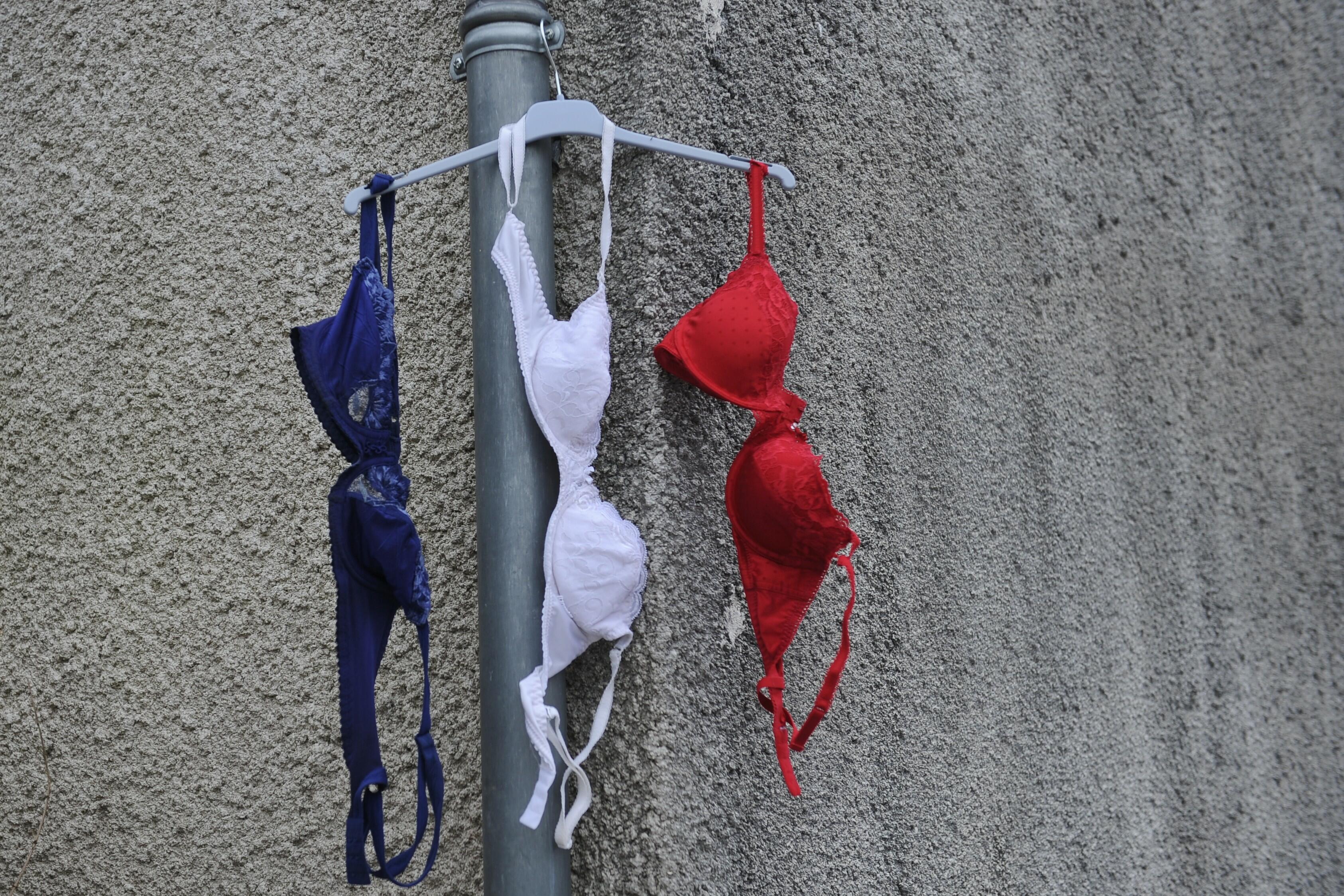 Bras in the colors of the French national flag hang from a house's gutter in La Rochelle, southwestern France, on NOvember 27, 2015 during a day of national tribute to the 130 people killed in the November 13 Paris attacks.  / AFP / XAVIER LEOTY        (P