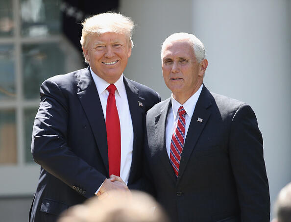 WASHINGTON, DC - JUNE 01:  U.S. President Donald Trump shakes hands with Vice President Mike Pence prior to announcing his decision regarding the United States' participation in the Paris climate agreement in the Rose Garden at the White House June 1, 2017 in Washington, DC. Trump pledged on the campaign trail to withdraw from the accord, which former President Barack Obama and the leaders of 194 other countries signed in 2015. The agreement is intended to encourage the reduction of greenhouse gas emissions in an effort to limit global warming to a manageable level.  (Photo by Win McNamee/Getty Images)