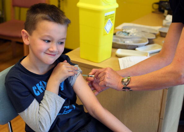 Luke Tanner, 7, receives the combined Measles Mumps and Rubella (MMR) vaccination at an MMR drop-in clinic at Neath Port Talbot Hospital near Swansea in south Wales on April 20, 2013. Public health officials said on April 19 they were investigating the fi