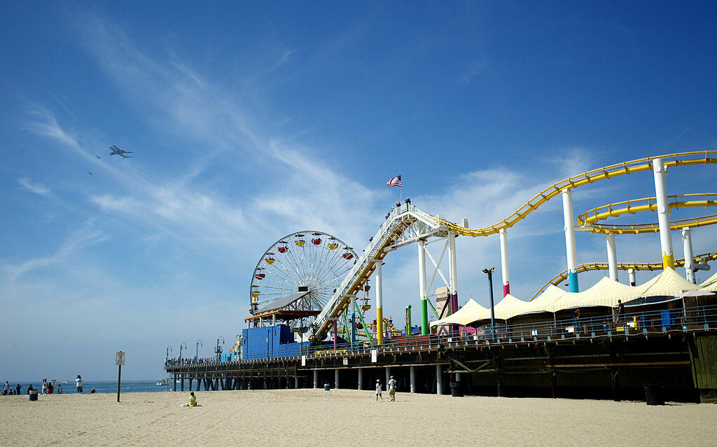 SANTA MONICA, CA - SEPTEMBER 21:  Space shuttle Endeavour, sitting on top of NASA's Shuttle Carrier Aircraft or SCA flies past Santa Monica Pier on September 21, 2012 in Santa Monica, California.  The Space Shuttle Endeavour will be placed on public displ