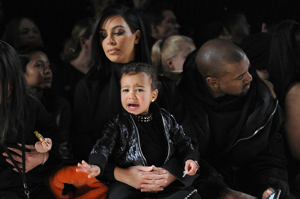 NEW YORK, NY - FEBRUARY 14:  (L-R) Kim Kardashian, North West and Kanye West attend the Alexander Wang Fashion Show during Mercedes-Benz Fashion Week Fall 2015 at Pier 94 on February 14, 2015 in New York City.  (Photo by Craig Barritt/Getty Images)