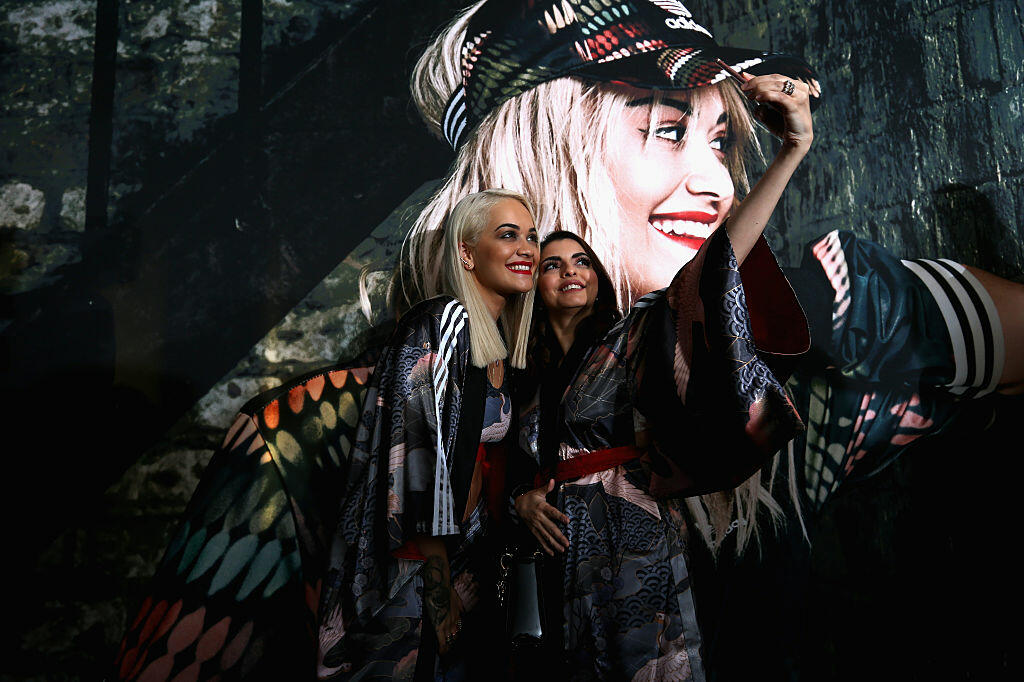 DUBAI, UNITED ARAB EMIRATES - FEBRUARY 10:  Rita Ora poses for a picture with a fan as she launches her adidas Originals Rita Ora SS16 collection at the Originals store at Dubai Mall on February 10, 2016 in Dubai, United Arab Emirates.  (Photo by Warren Little/Getty Images)