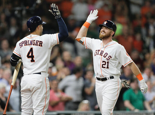 HOUSTON, TX - JUNE 14:  Derek Fisher #21 of the Houston Astros receives a high five from George Springer #4 after hitting his first majorl league home run as well as first major league hit against the Texas Rangers at Minute Maid Park on June 14, 2017 in Houston, Texas.  (Photo by Bob Levey/Getty Images)
