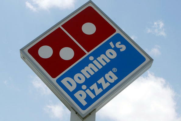 MIAMI, FL - APRIL 14: A sign in front of a  Domino's Pizza April 14, 2004 in Miami, Florida. Domino's Pizza is looking to raise $300 million in the stock market by listing on the New York Stock exchange. The Michigan-based firm already has a London stock 