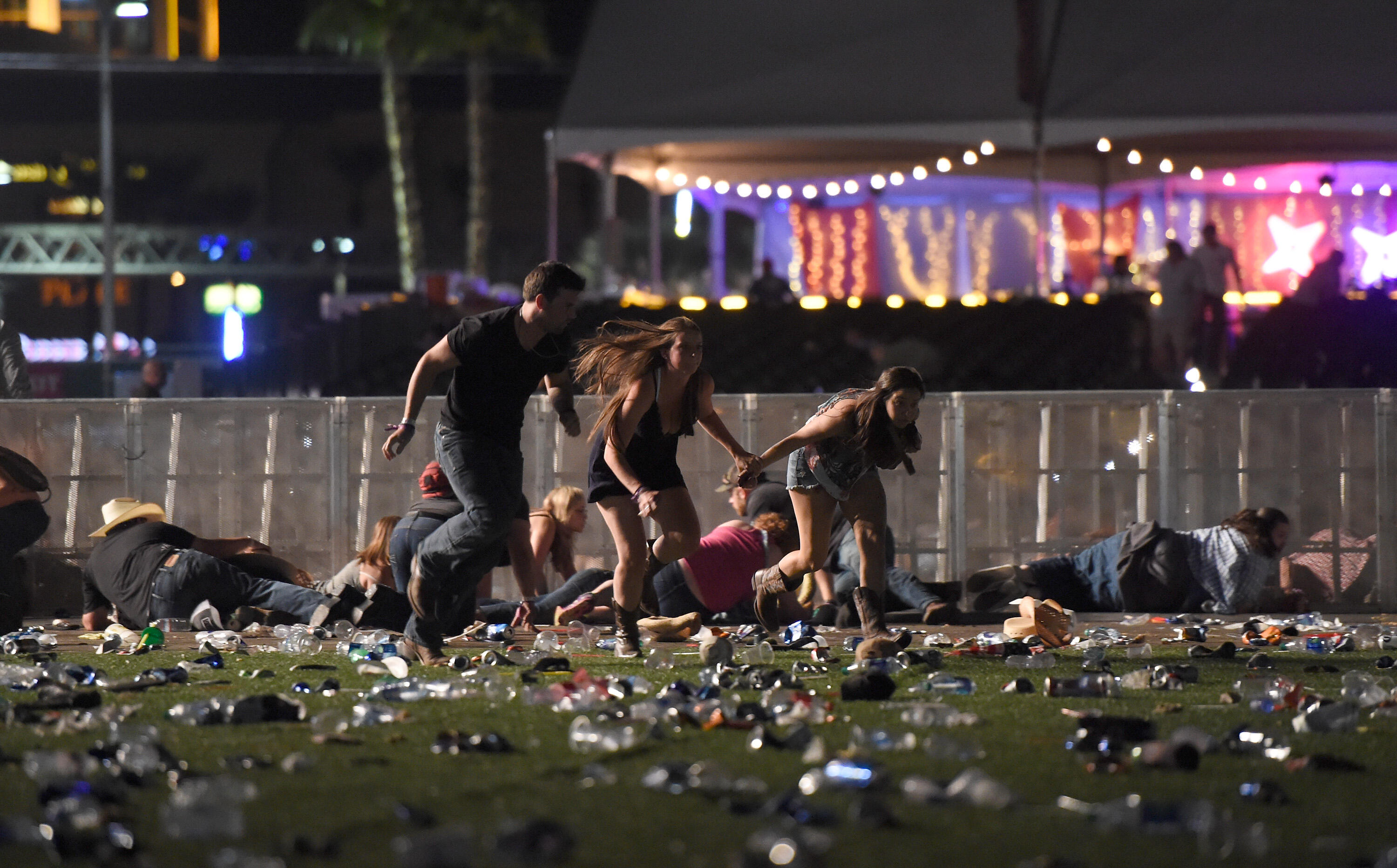 LAS VEGAS, NV - OCTOBER 01 People run from the Route 91 Harvest country music festival after the apparent gunfire was heard on October 1, 2017, in Las Vegas, Nevada. There are reports of an active shooter around the Mandalay Bay Resort and Casino. (Photo by David Becker/Getty Images)