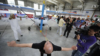 Man Pulls Plane with Eyelids