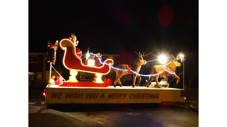 Image of Christmas carnival float with Santa Claus and reindeer