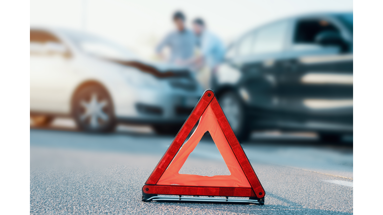 Two men reporting a car crash for insurance claim