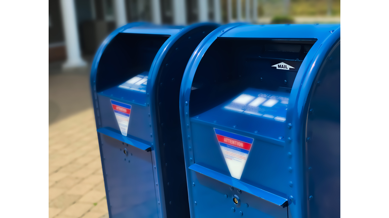 two traditional blue postal mailboxes side by side