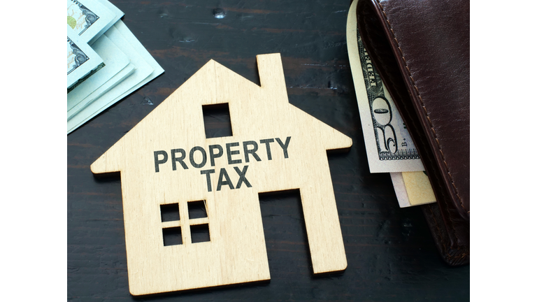 Property tax sign on a house model.