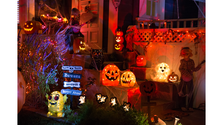 A house with Halloween pumpkins and halloween decorations at  Halloween night on a city street. Trick or treat.