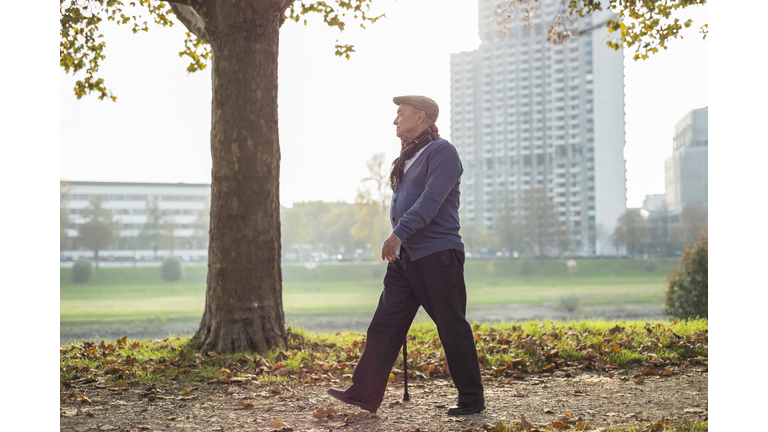 Senior man walking by the riverside