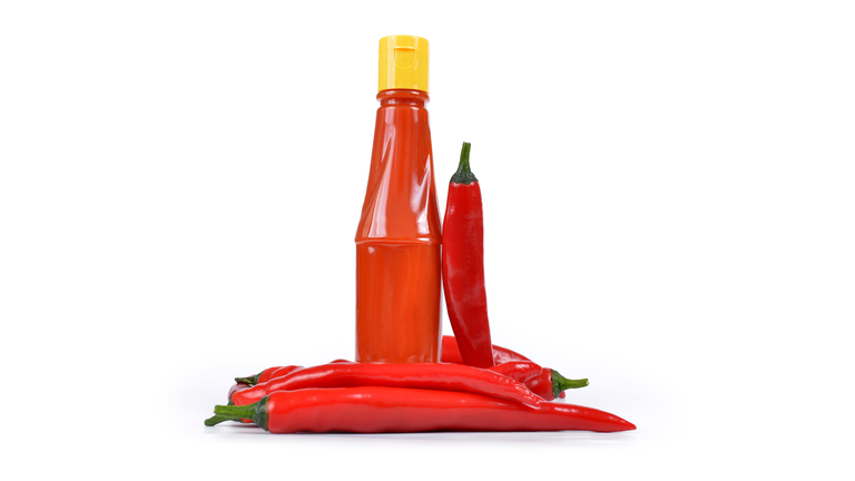 Hot sauce in bottle with Red chili pepper
