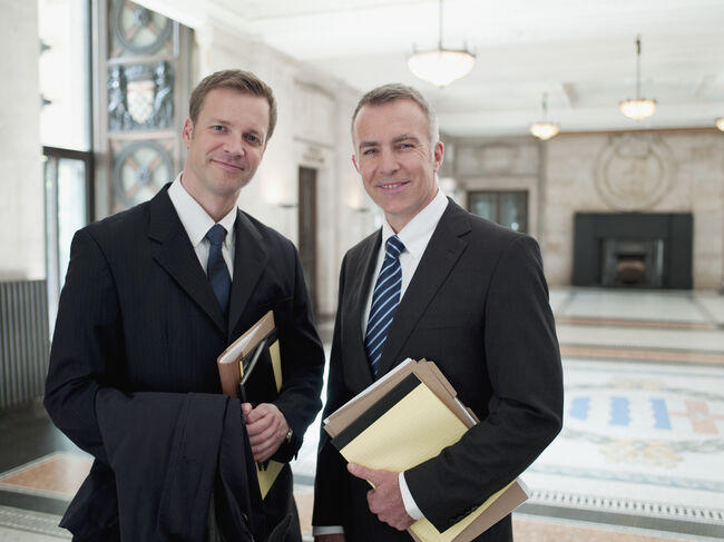 Smiling businessmen in lobby