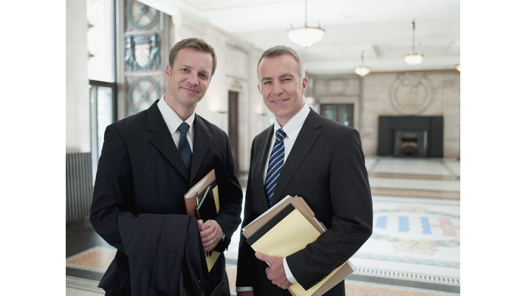 Smiling businessmen in lobby