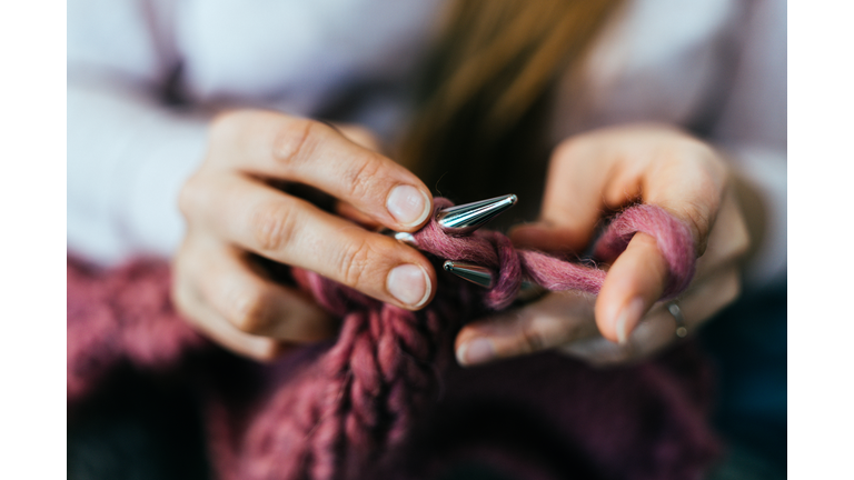 Woman knitting.