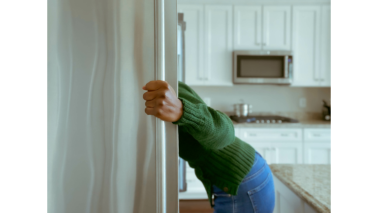 Woman Looks into Refrigerator for Healthy Snack