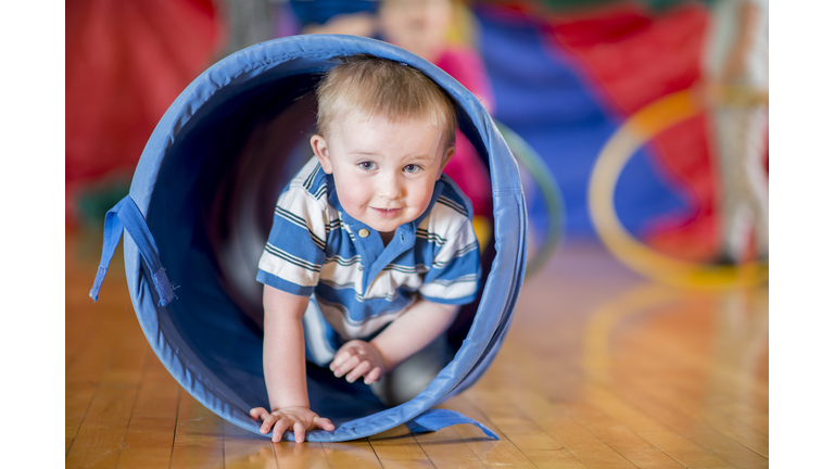 Little Boy Crawling Through Play Tunnel