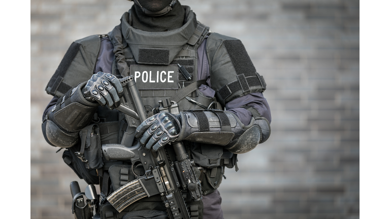 SWAT Police Officer Against Brick Wall