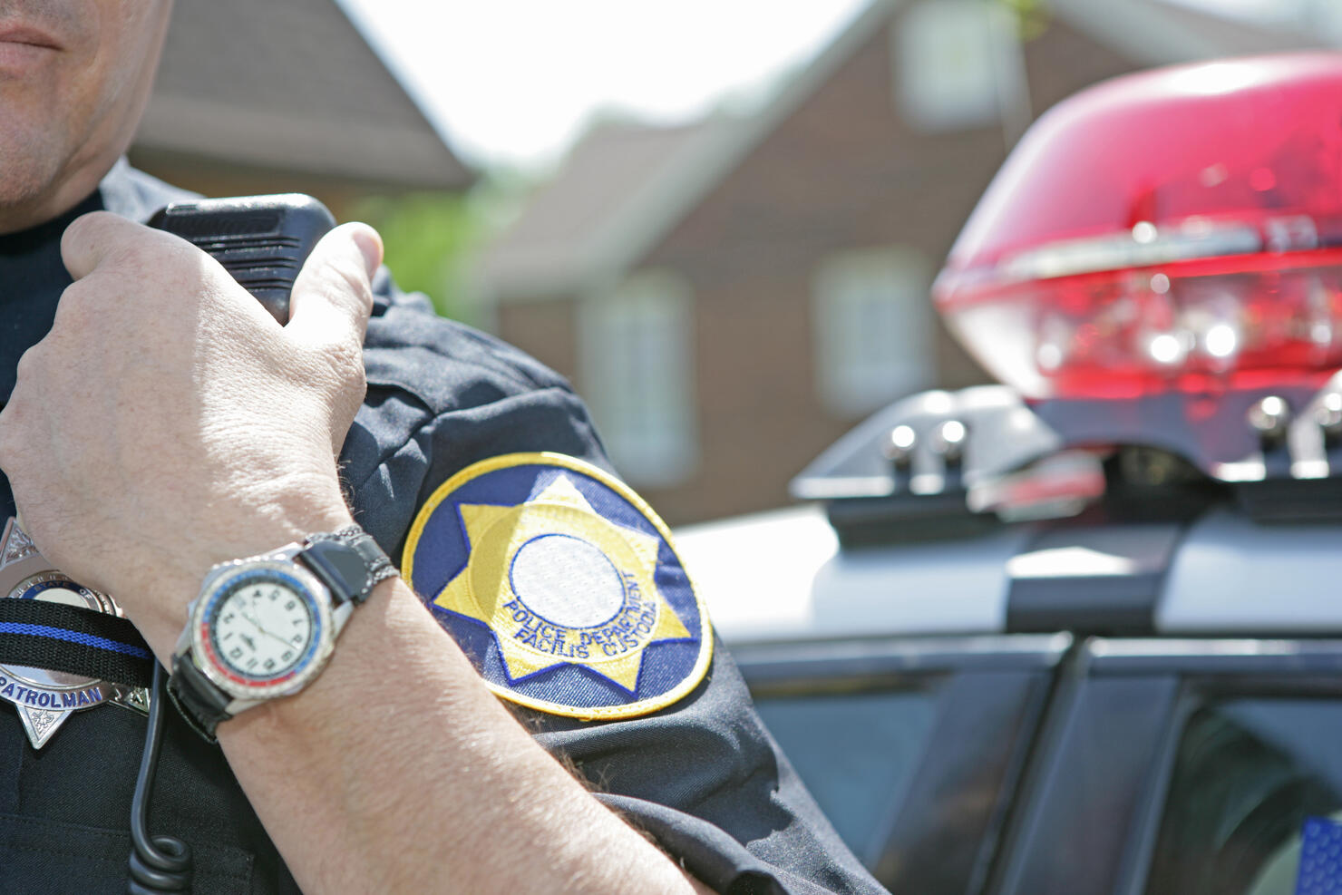 Police officer using radio to call for backup