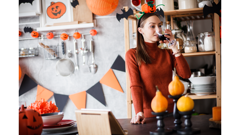 Girl drinking wine on Halloween