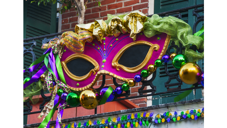 USA, New Orleans, Louisiana, Mardi Gras mask hanging on balcony's railing